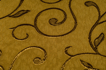 Texture, background, pattern. Damask fabric with shiny patterns on a matte background .. Golden...