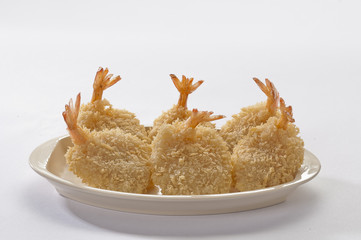 Breaded Butterfly Jumbo Shrimps with salad and salsa dip on white plate and white background 