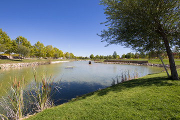 Fototapeta na wymiar lake and park with fountain, ducks and green grass in Valdeluz town, near Guadalajara, Spain, Europe 