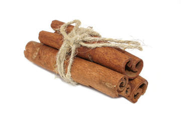 Cinnamon bark tied with rope isolated on white background. close-up.