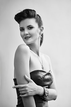 Beautiful girl in a leather dress in rock and roll slyle, black and white photo