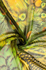 Background texture, drawing. Silk fabric. Light airy fabric. Green with peacock feathers. Yellow shade. Fabric cotton silk batiste mint green airy very light transparency - obrazy, fototapety, plakaty
