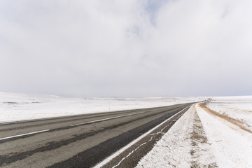 Winter landscape, road through the steppe