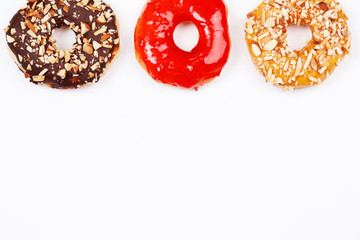 Delicious donuts with chocolate almond, strawberry jam and almond caramel glazed, Isolated on white background. Selective focus.