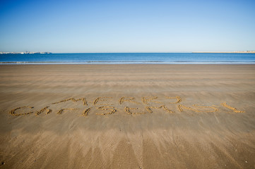 Merry Christmas! Someone has written a congratulation on sea sand.