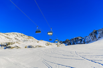Fototapeta na wymiar Ski slopes and ski lifts in the Alps. 