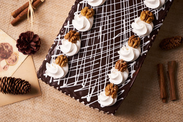 Chocolate cake with whipped cream and walnut