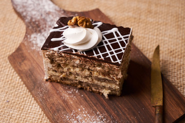Chocolate cake with whipped cream and walnut