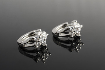 silver earrings with diamonds isolated on black