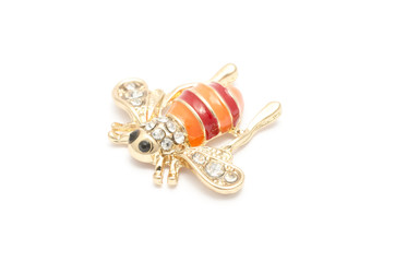 Golden brooch bee with diamonds isolated on white