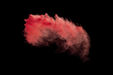 Explosion of red powder isolated on black background