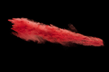 Fototapeta na wymiar Explosion of red powder isolated on black background