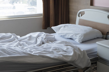 Fototapeta na wymiar White Patient bed in nice hospital room .White Patient bed in nice hospital room .