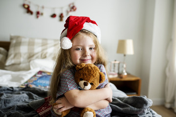 Little girl hugging a toy bear