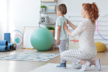 Child physiotherapist examining patient spine