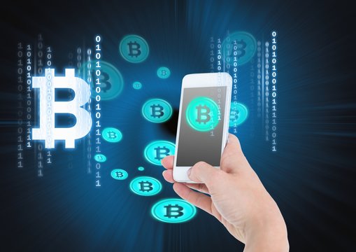 Bitcoin icons and hand holding phone