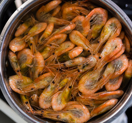 Shrimps boil in pan. Selective focus with shallow depth of field.