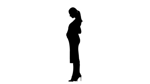 Pregnant woman is standing and stroking her stomach. Silhouette. White background. Slow motion