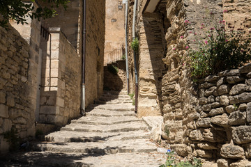 Steep alley with medieval houses in Gordes. Provence, France