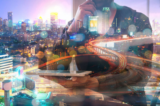 Double Exposure of Man or Male hold Digital Wireless Tablet with Glowing Modern City Scenic