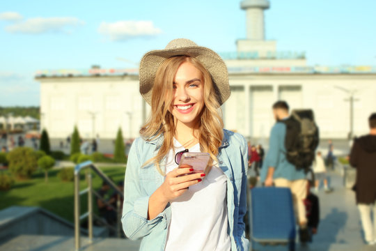 Young female tourist with mobile phone outdoors