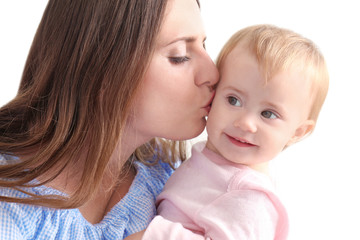 Young mother holding cute baby at home