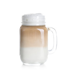 Mason jar with latte macchiato on white background