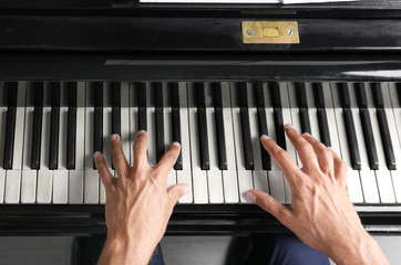 Young man playing piano, closeup