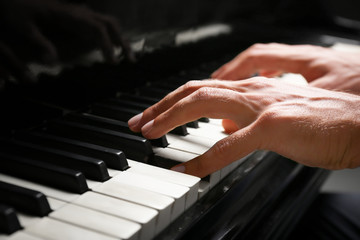 Young man playing piano, closeup