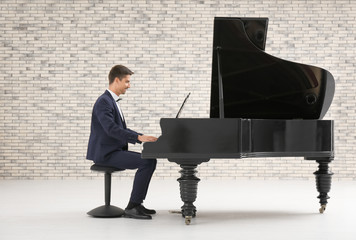 Young man playing piano indoors
