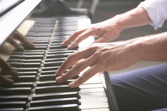 Young man playing piano, closeup