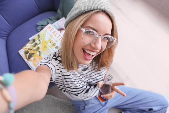 Attractive Hipster Girl Taking Selfie At Home