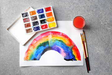 Fototapeta premium Watercolor painting of rainbow on grey table