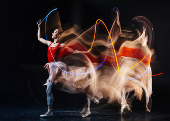 Active sport. Beautiful nice young woman standing on stage and practicing dance movements while...
