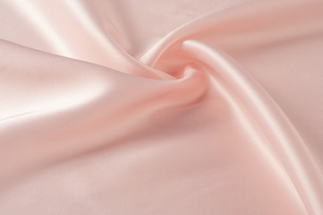 Texture, background, pattern. Fabric silk pink background. Beautiful pink satin. Drapery background. winds waves, creating a beautiful background of the folds.