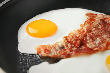 Frying pan with egg and bacon, closeup