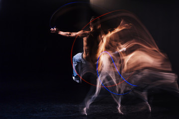 Up in the air. Handsome well built skillful man jumping and doing dance movements while being in the air