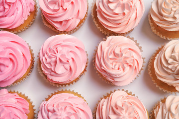 Many yummy cupcakes on white background