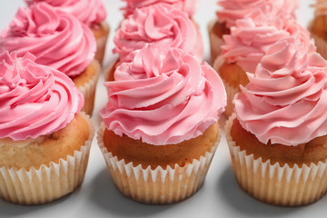 Many yummy cupcakes on white background