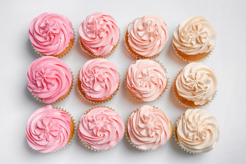 Many yummy cupcakes on white background
