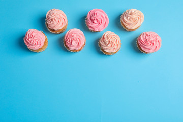 Fototapeta na wymiar Many yummy cupcakes on color background
