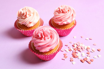 Yummy cupcakes on color background