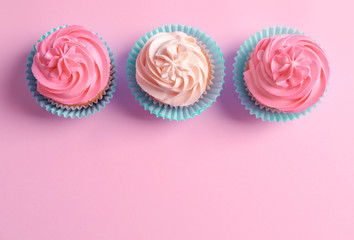 Yummy cupcakes on color background