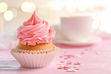 Yummy cupcake on blurred background