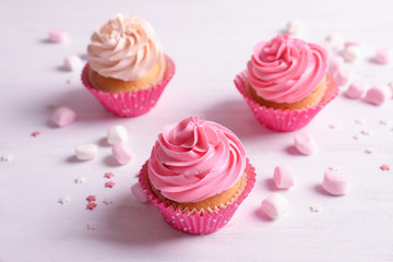 Yummy cupcakes on wooden table