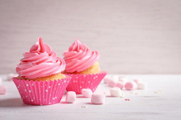 Yummy cupcakes on wooden table