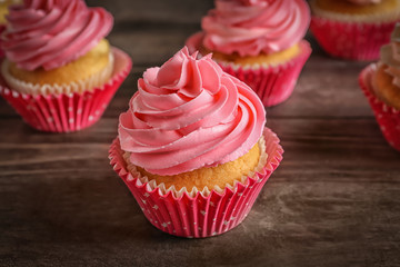 Yummy cupcakes on wooden table
