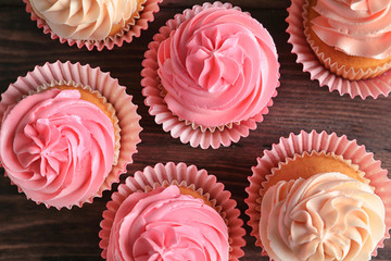 Yummy cupcakes on wooden table