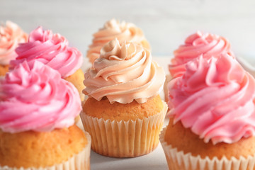 Yummy cupcakes on wooden table, closeup