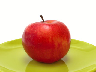 Red apple on green plate, healthy food